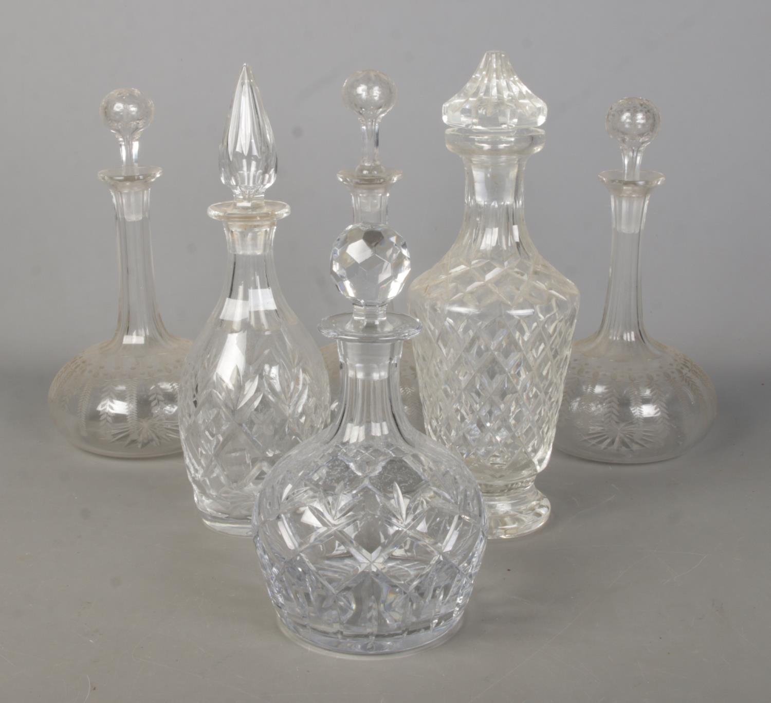 Six glass decanters, including cut, etched and ships style examples.