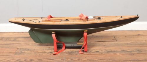 A vintage kit built pond yacht motorised model boat on display stand. Approx. boat length 113cm