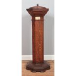 An oak pedestal font of octagonal form, with metal bowl liner and lid. Bearing plaque to the