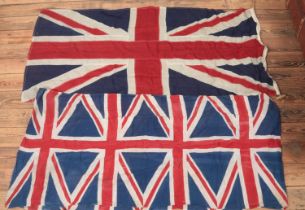 Two vintage Union Jacks; one as a slender banner, the other stamped for Flags Ltd, Leeds. Length