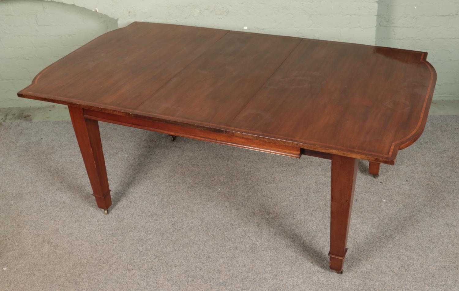A mahogany inlaid dining table with square tapering legs sat on brass castors. Comes with one - Image 2 of 2