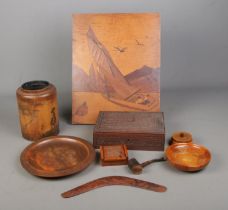 A collection of assorted treen to include boomerang, decorative fishing scene, carved dish, Ropp