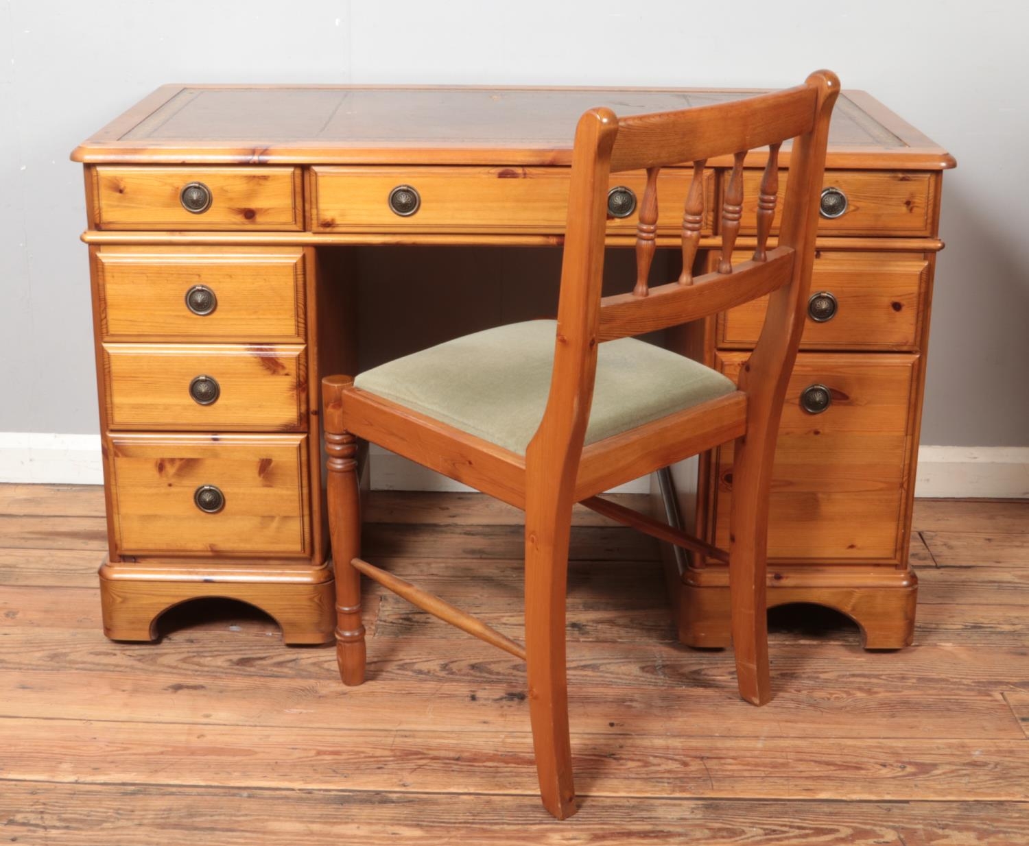 A pine knee hole with leather inset top and fitted central drawer along with corresponding velvet