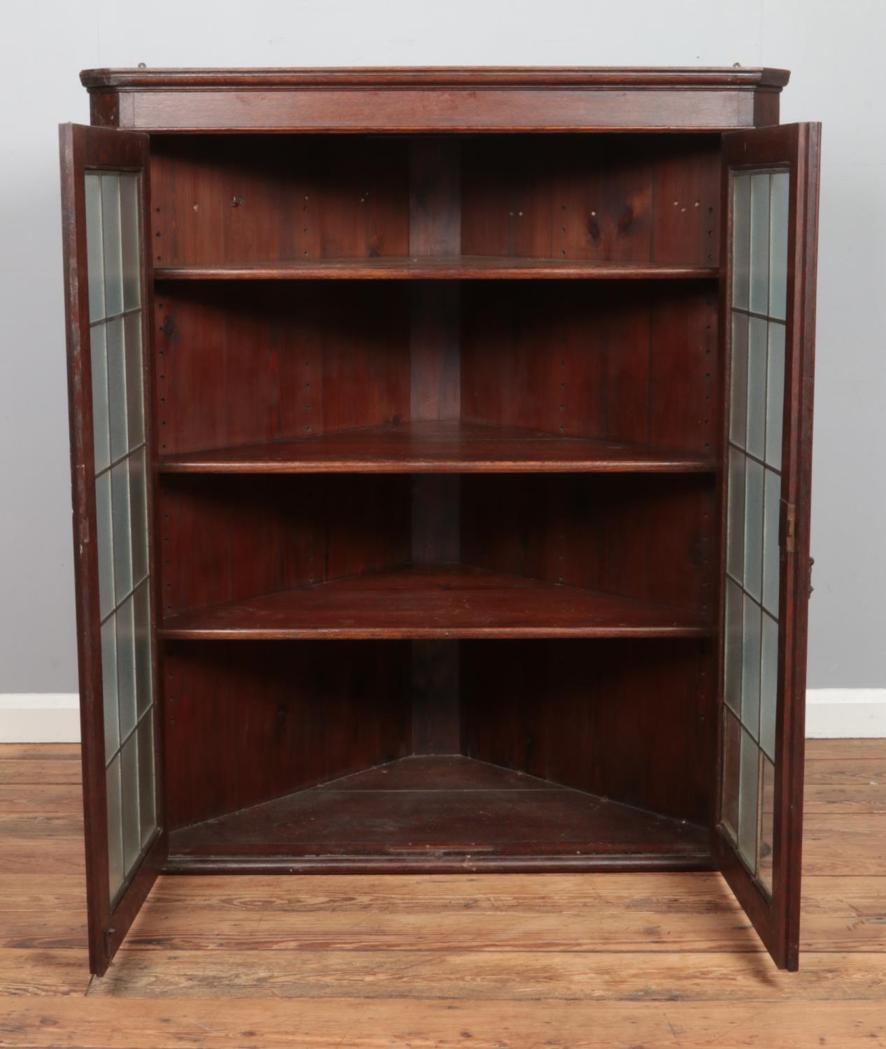 A large Georgian style oak wall mounted corner cupboard, with twin lead glazed doors. Height: 127cm, - Image 2 of 2