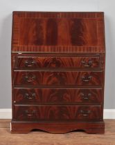 A mahogany four drawer bureau, with drop down desk revealing partially fitted interior. Height: