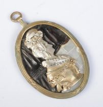 A large pendant depicting a portrait of a maiden. The portrait set in white and yellow metal, having