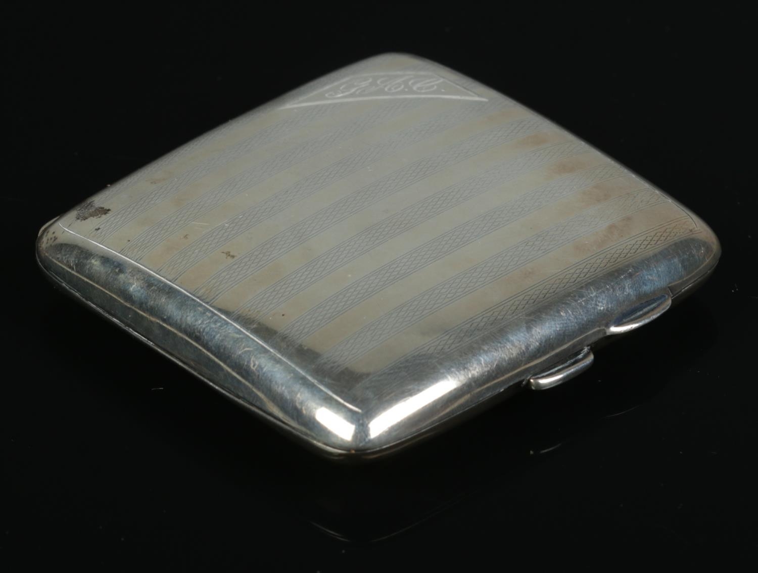 A George V silver hinged cigarette case, with banded detailing and corner cartouche with initials