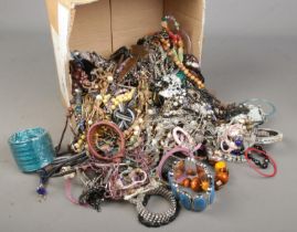 A box of assorted modern costume jewellery. Includes bracelets, bangles, necklaces etc.