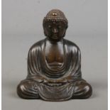A small bronze figure of a seated Buddha. Signed to base. Height 6cm.