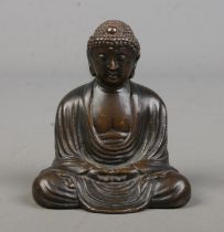 A small bronze figure of a seated Buddha. Signed to base. Height 6cm.
