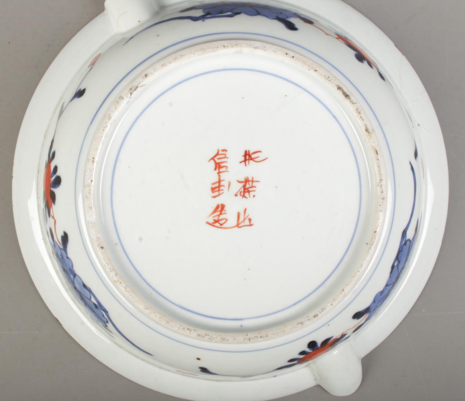 A Japanese Meiji period Imari plate warmer bearing central dragon motif and six character mark to - Image 3 of 3