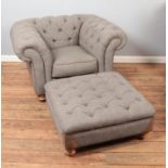 A grey fabric chesterfield armchair and footstool with leather accents.