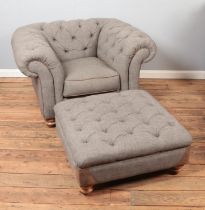 A grey fabric chesterfield armchair and footstool with leather accents.
