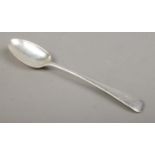 An Edwardian silver basting spoon with 'C' stenciled to the top of the handle. Assayed for