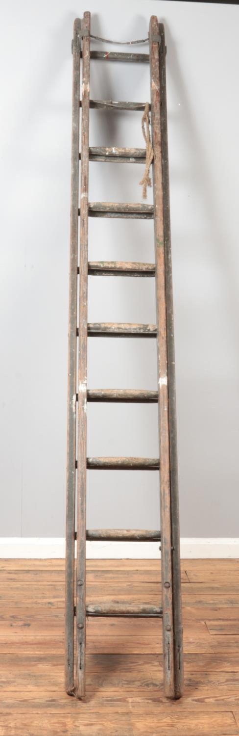 A wooden extendable ladder. Unextended length approximately 275cm.