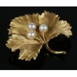 An 18ct Gold maple leaf brooch, set with three pearls. Stamped 18 and 750 to the reverse; Bears