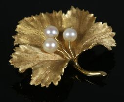 An 18ct Gold maple leaf brooch, set with three pearls. Stamped 18 and 750 to the reverse; Bears