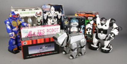 A collection of retro toy robots including Robosapien, Cyberdog, Q-Robot, Disc Shooting Mr Robot,