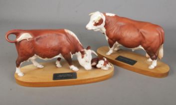 Two Beswick Connoisseur models; Hereford Bull and Hereford Cow and Calf.