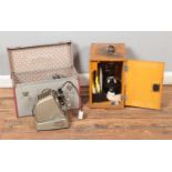 A boxed Model L-201 Microscope and accessories along with a cased Aldis projector.