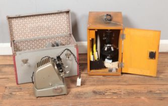 A boxed Model L-201 Microscope and accessories along with a cased Aldis projector.