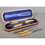 A cased three piece Joseph Rodgers bone handled carving set, together with one other uncased