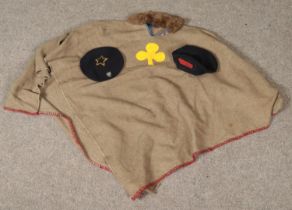 A vintage girl guides poncho along with two berets.