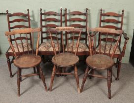 A set of four ladder back chairs with another three stick back chairs