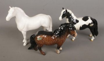 Three Beswick ceramic horses to include Palamino and Shetland examples. All with various repairs.