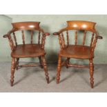 A near pair of beech and elm smokers bow armchairs.