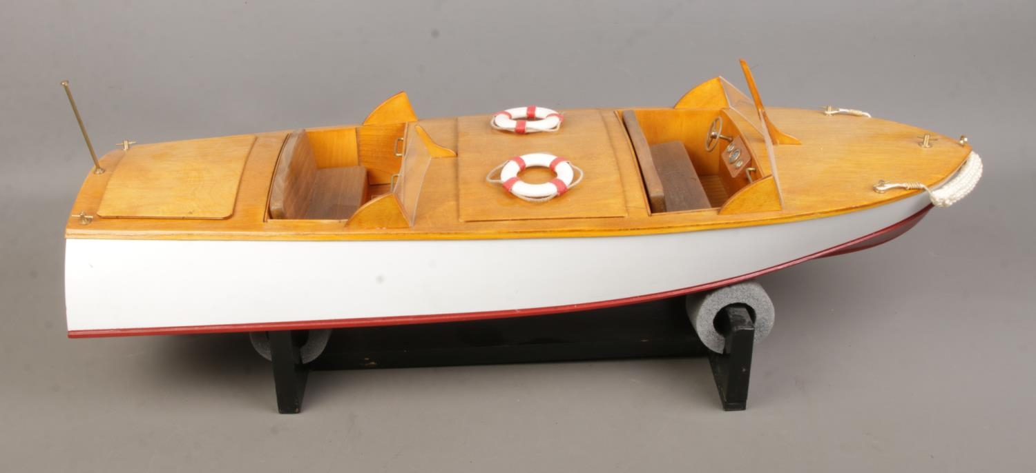 A remote control model pond cruiser titled Sea Hornet with display stand. Approx. boat length 65cm.