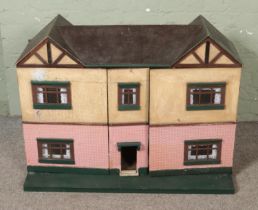 A very large vintage dolls house with fold away open front