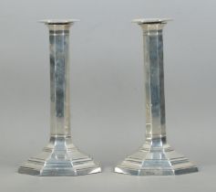 A quality pair of George V silver filled candlesticks of octagonal form, featuring stepped bases.