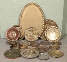 A large collection of brass and metalware plaques, plates and trays.