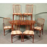 A Mcintosh teak extending dining table with six chairs including two carvers. Table not extended