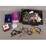 A box of assorted costume jewellery to include bangles, beaded necklaces, brooches, rings, etc.