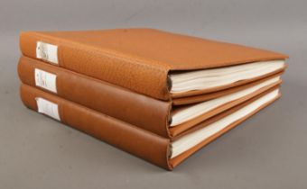 Three empty Linder Great British stamp albums, with pre-printed pages for between 1983-2001.