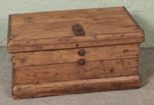 A rustic pine trunk with cast iron hasp lock lid