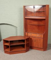 Two pieces of G Plan teak corner furniture to include tv stand and cabinet featuring glass doors and