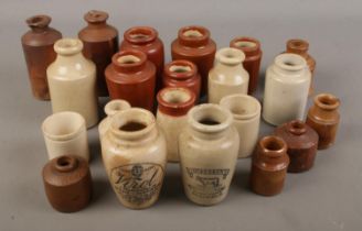 A collection of small stoneware bottles including some being labelled "Virol, A preparation of