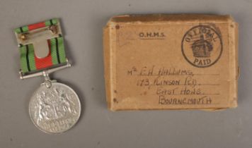 A WWII Defence Medal awarded to F.W Hallums, Homeguard with coordinating ribbons and original box.