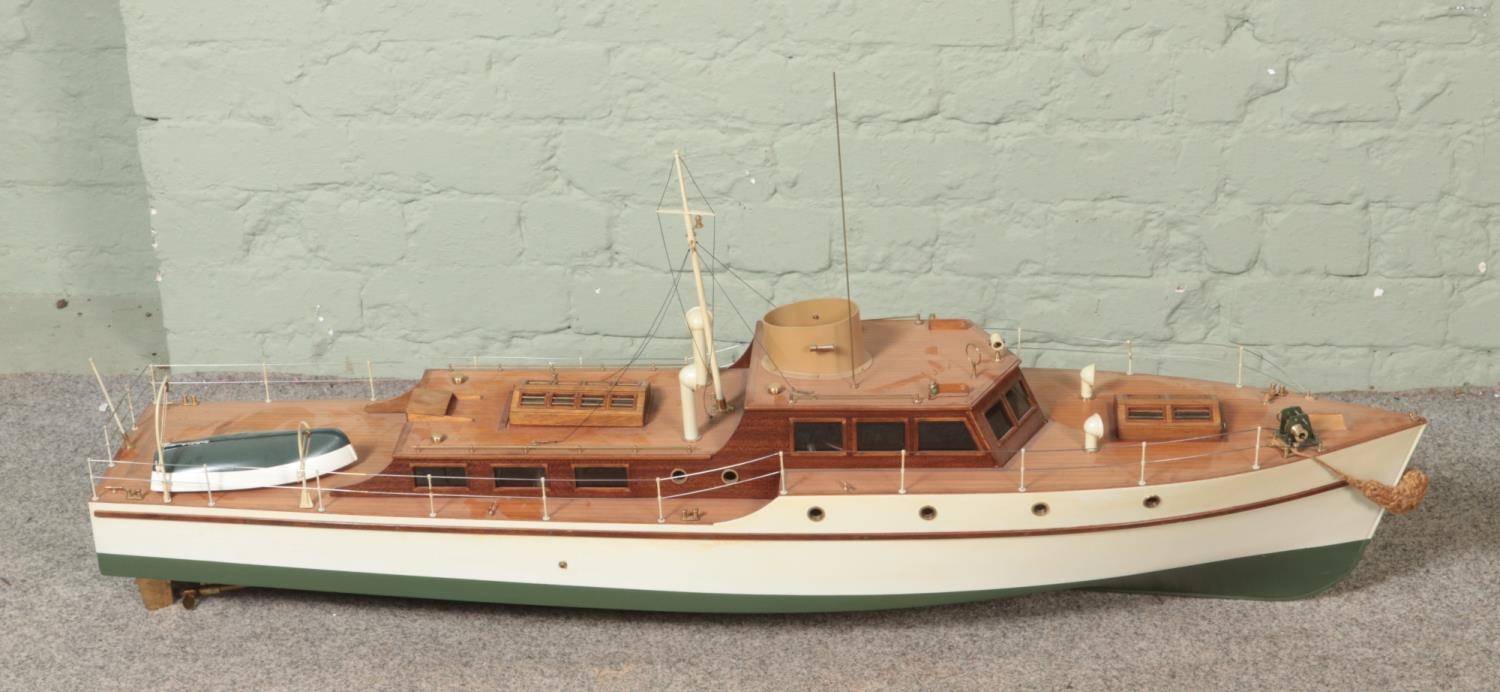 A large remote control pond model of a single funnel steam ship decorated with rowing boat and mast.