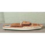 A large remote control pond model of a single funnel steam ship decorated with rowing boat and mast.