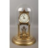 A anniversary style clock with quartz movement. Housed under glass dome.