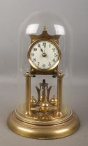 A anniversary style clock with quartz movement. Housed under glass dome.