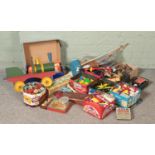 A large collection of vintage toys and games, including Meccano pieces, Lego, Carpet Bowls, tiddly