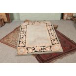 A collection of three floor rugs including bokhara design.