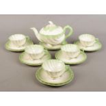 A Belleek shell design 'Neptune' tea set. Comprises of teapot, six saucers, six side plates and five