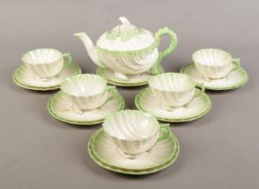 A Belleek shell design 'Neptune' tea set. Comprises of teapot, six saucers, six side plates and five