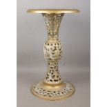 An ornate pierced brass side table, on circular base. Height: 48cm.